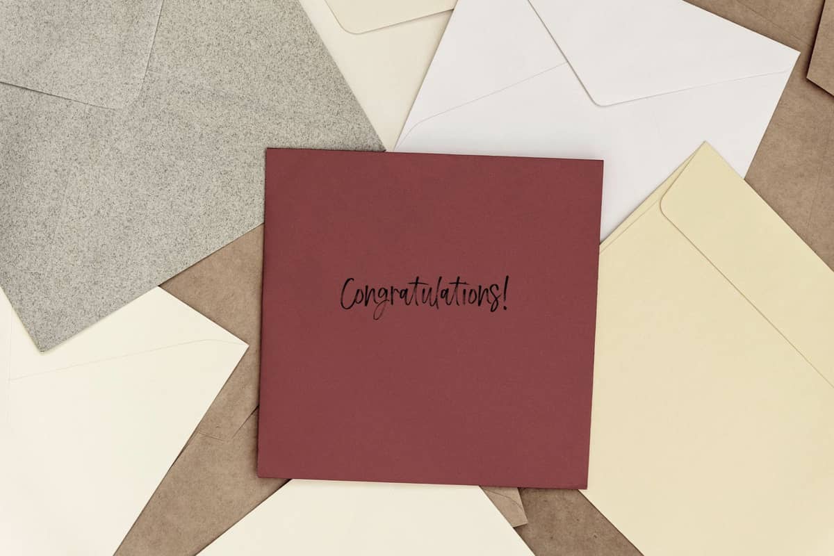 Envelopes with a red one in the center that says "Congratulations!"