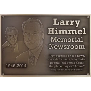 Close up of a custom bronze memorial plaque featuring two highly detailed 3D bas-relief sculpted portraits.