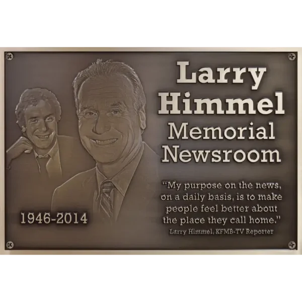 Close up of a custom bronze memorial plaque featuring two highly detailed 3D bas-relief sculpted portraits.