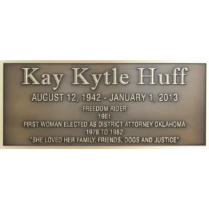 Rectangular bronze historical civic memorial plaque with clean raised lettering dedicating a local hero.