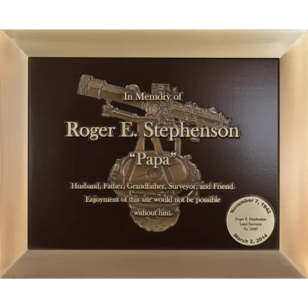 Custom cast bronze profession memorial plaque featuring a 3D sculpted surveyor telescope.