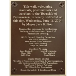 Rectangular bronze municipal dedication plaque listing township council members and sponsors.