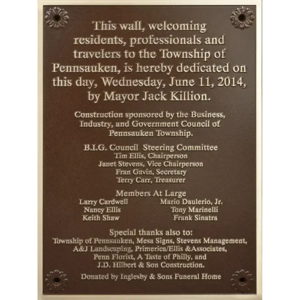 Rectangular bronze municipal dedication plaque listing township council members and sponsors.