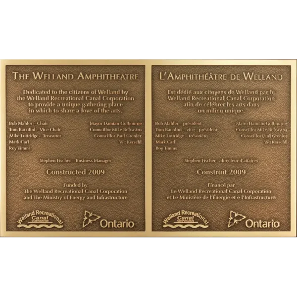 Bilingual cast bronze park dedication plaque for an amphitheatre featuring English and French text.