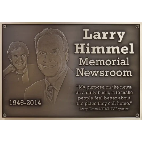Close up of a custom bronze memorial plaque featuring two highly detailed 3D bas-relief sculpted portraits.