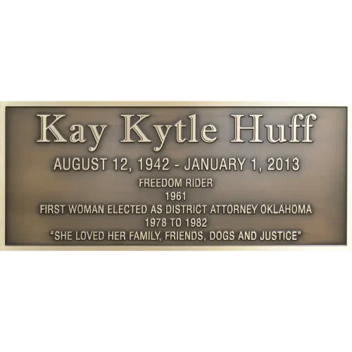 Rectangular bronze historical civic memorial plaque with clean raised lettering dedicating a local hero.