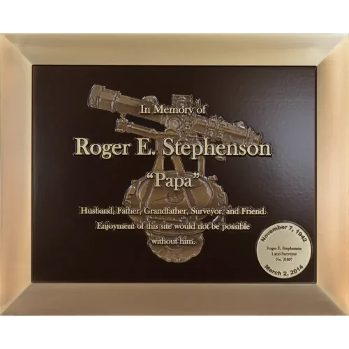 Custom cast bronze profession memorial plaque featuring a 3D sculpted surveyor telescope.