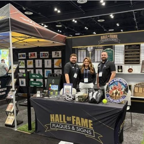 The team at their booth for Hall of Fame Plaques