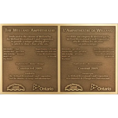 Bilingual cast bronze park dedication plaque for an amphitheatre featuring English and French text.